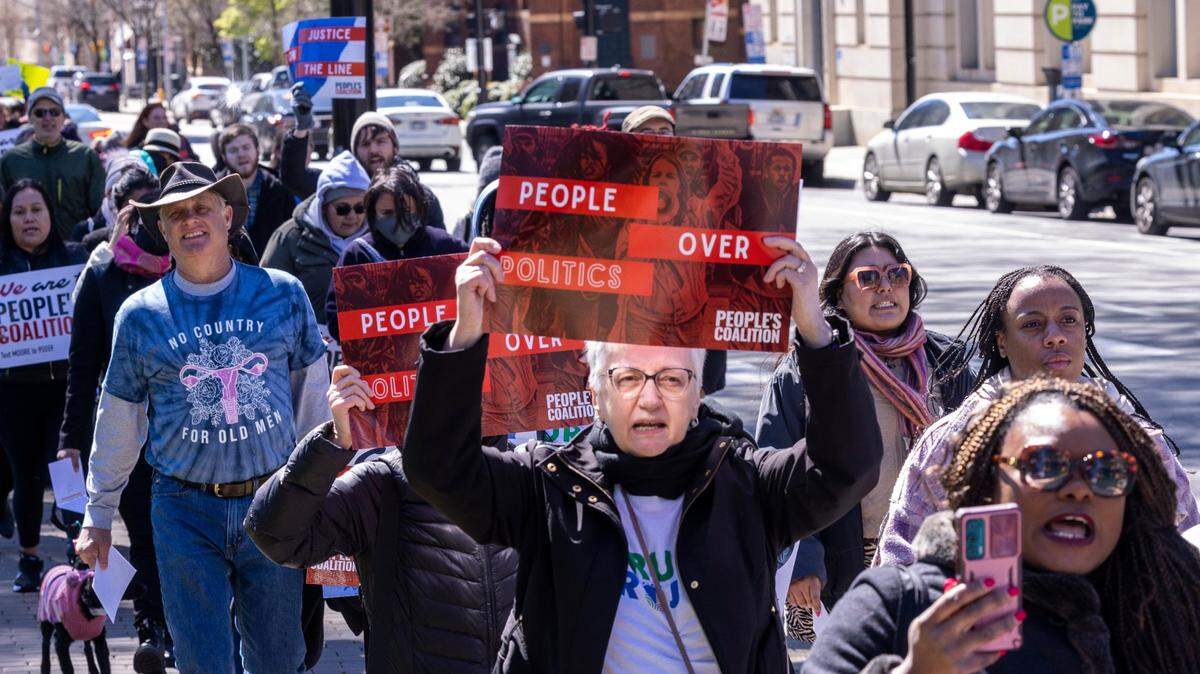 Activists march from the North Carolina State Capitol to the Legislative Office Building on March 14, 2022 in support of voting rights.