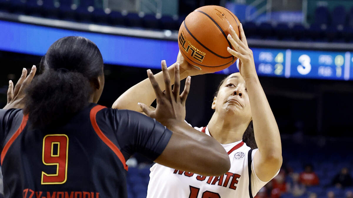N.C. State's Khamil Pierre (12) shoots as Maryland's Isimenme Ozzy-Momodu (9) defends during the first half of N.C. State’s exhibition game against Maryland at the First Horizon Coliseum in Greensboro, N.C., Sunday Oct. 26, 2025.