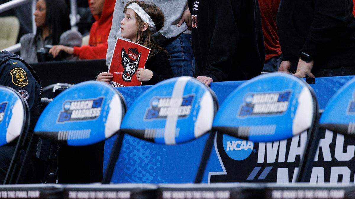 A young N.C. State fan watches during the second half of the Wolfpack’s 79-73 overtime win against Oakland in the second round of the NCAA Tournament on Saturday, March 23, 2024, at PPG Paints Arena in Pittsburgh, Pa.
