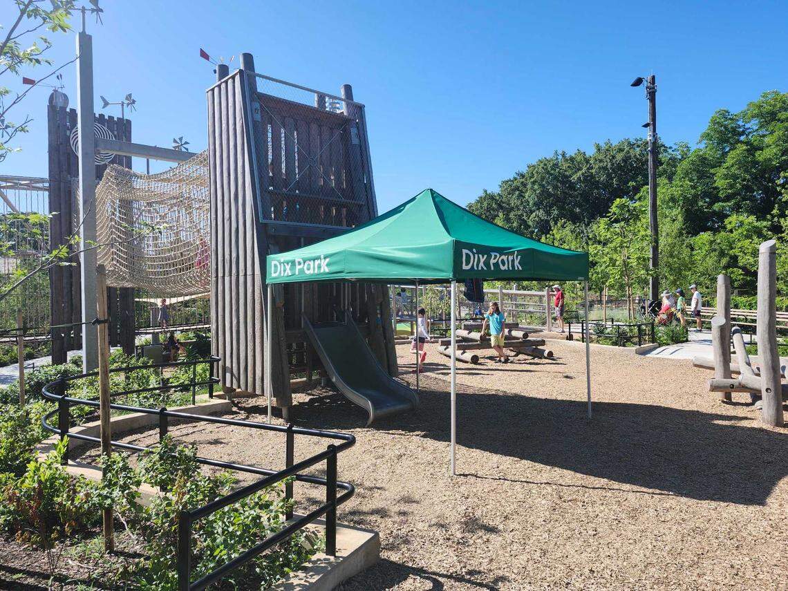 A pop-up tent shades a metal slide at the Gipson Play Plaza on June 18, 2025.