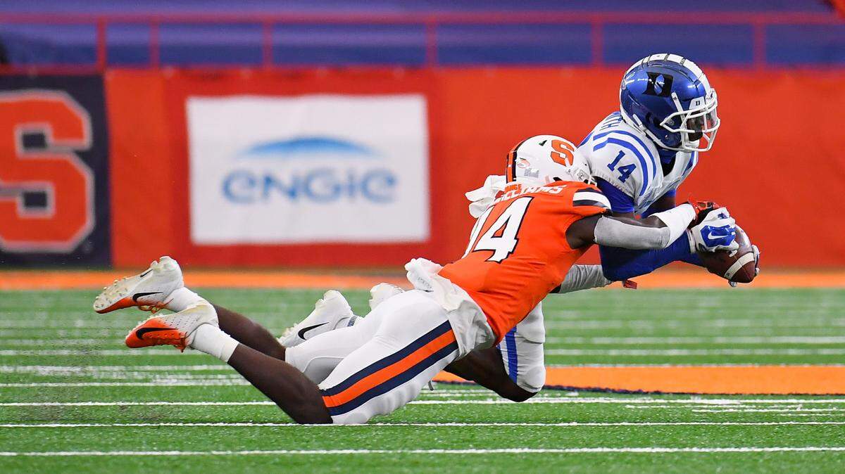Duke Blue Devils wide receiver Dennis Smith (14) catches a pass as Syracuse Orange defensive back Garrett Williams (14) defends during the first quarter at the Carrier Dome.
