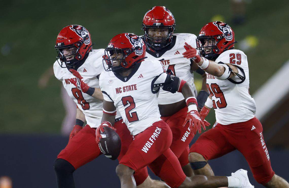 N.C. State’s Ronnie Royal III (2) celebrates an interception with Cian Slone (8), Brandon Cleveland (44) and Brody Barnhardt (29) during the second half of N.C. State’s 34-24 victory over Wake Forest at Allegacy Stadium in Winston-Salem, N.C., Thursday, Sept. 11, 2025.