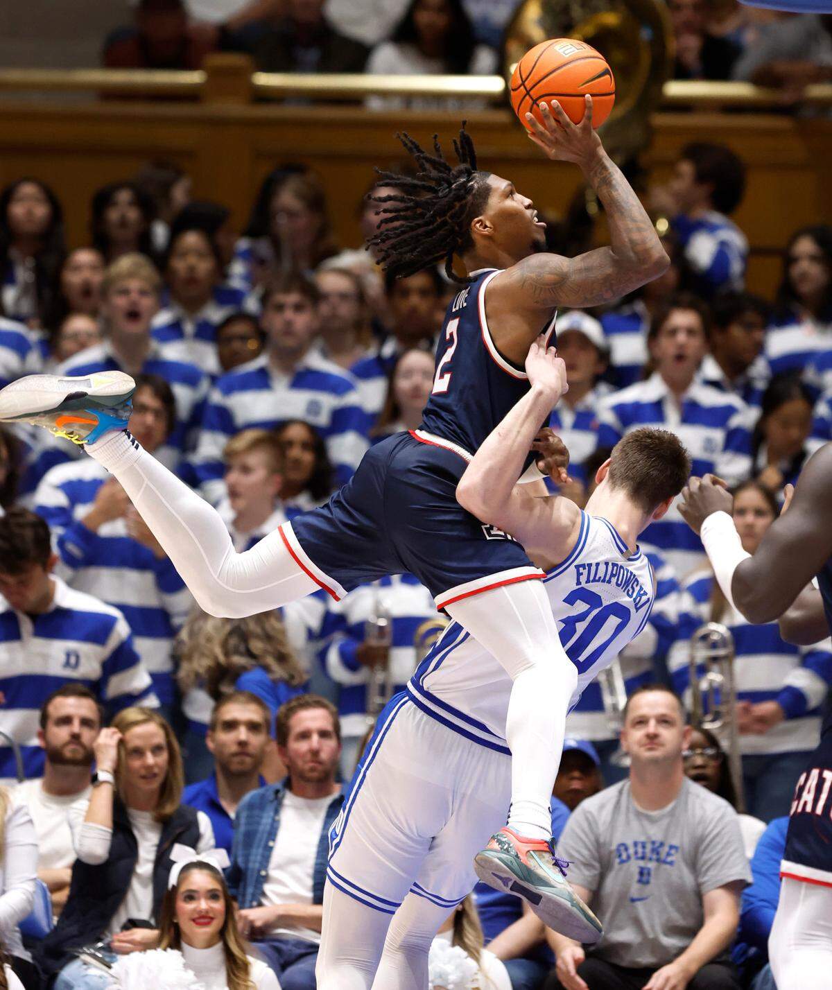 Duke’s Kyle Filipowski (30) draws the foul as Arizona’s Caleb Love (2) drives to the basket during the second half of Arizona’s 78-73 victory over Duke at Cameron Indoor Stadium in Durham, N.C., Friday, Nov. 10, 2023.
