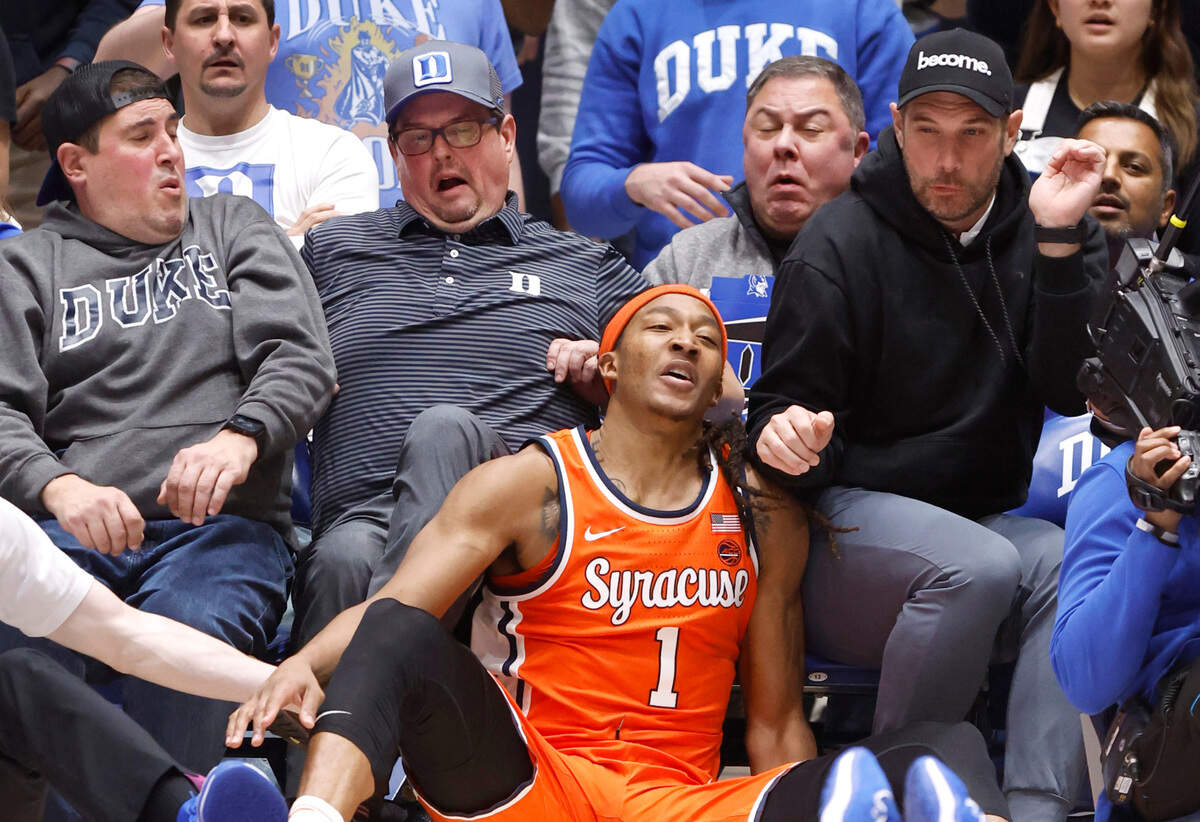 Syracuse’s Maliq Brown (1) falls into fans during the second half of Duke’s 86-66 victory over Syracuse at Cameron Indoor Stadium in Durham, N.C., Tuesday, Jan. 2, 2024.