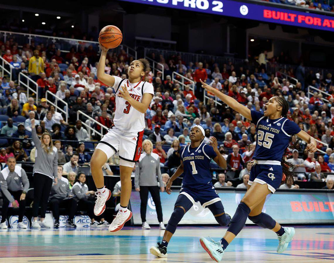 N.C. State’s Zamareya Jones gets past Georgia Tech’s Chazadi Wright and Kara Dunn for a lay-up during the first half of the Wolfpack’s 73-72 win in the ACC Tournament quarterfinals on Friday, March 7, 2025, at First Horizon Coliseum in Greensboro, N.C.
