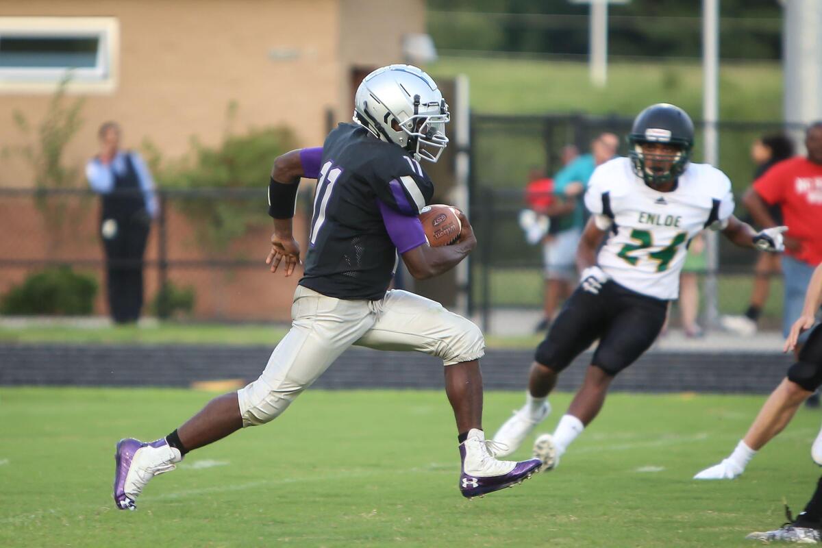 South Garner quarterback Teion Cole (11) returns a kickoff for a touchdown during the Enloe Eagles’ football game at the South Garner Titans on Monday, August 26, 2019. Enloe won the game 48-13.