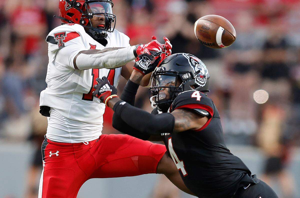 N.C. State safety Cyrus Fagan (4) breaks up a pass intended for Texas Tech wide receiver Xavier White (14) during the first half of N.C. State’s game against Texas Tech at Carter-Finley Stadium in Raleigh, N.C., Saturday, Sept. 17, 2022.