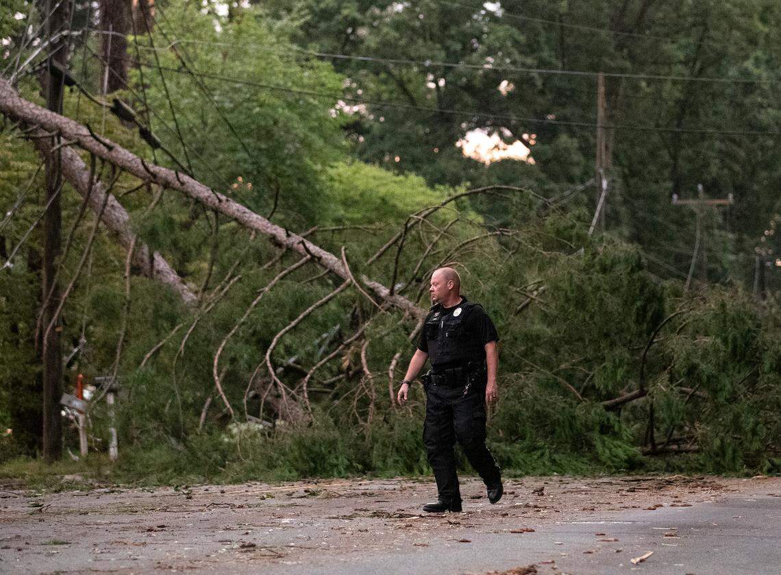 A downed tree blocks Cole Mill Road following strong storms in Durham, N.C. on Tuesday, Aug. 15, 2023.
