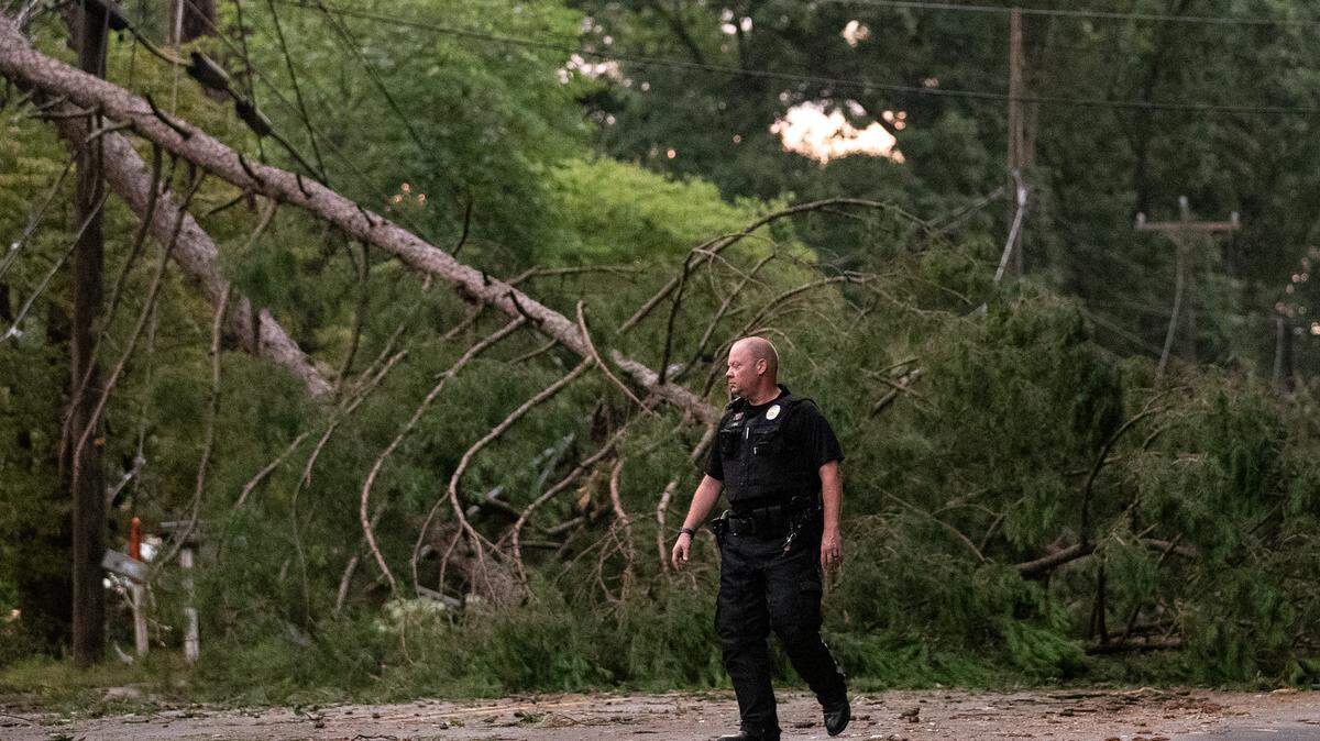 A downed tree blocks Cole Mill Road following strong storms in Durham, N.C. on Tuesday, Aug. 15, 2023.