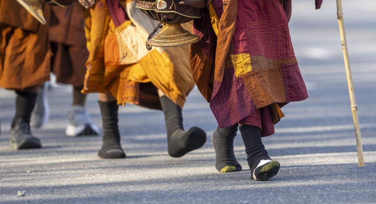 Buddhist Monks, in stocking feet,  walk along US 421 in Randolph County during the Walk For Peace on Wednesday, January 21, 2026 