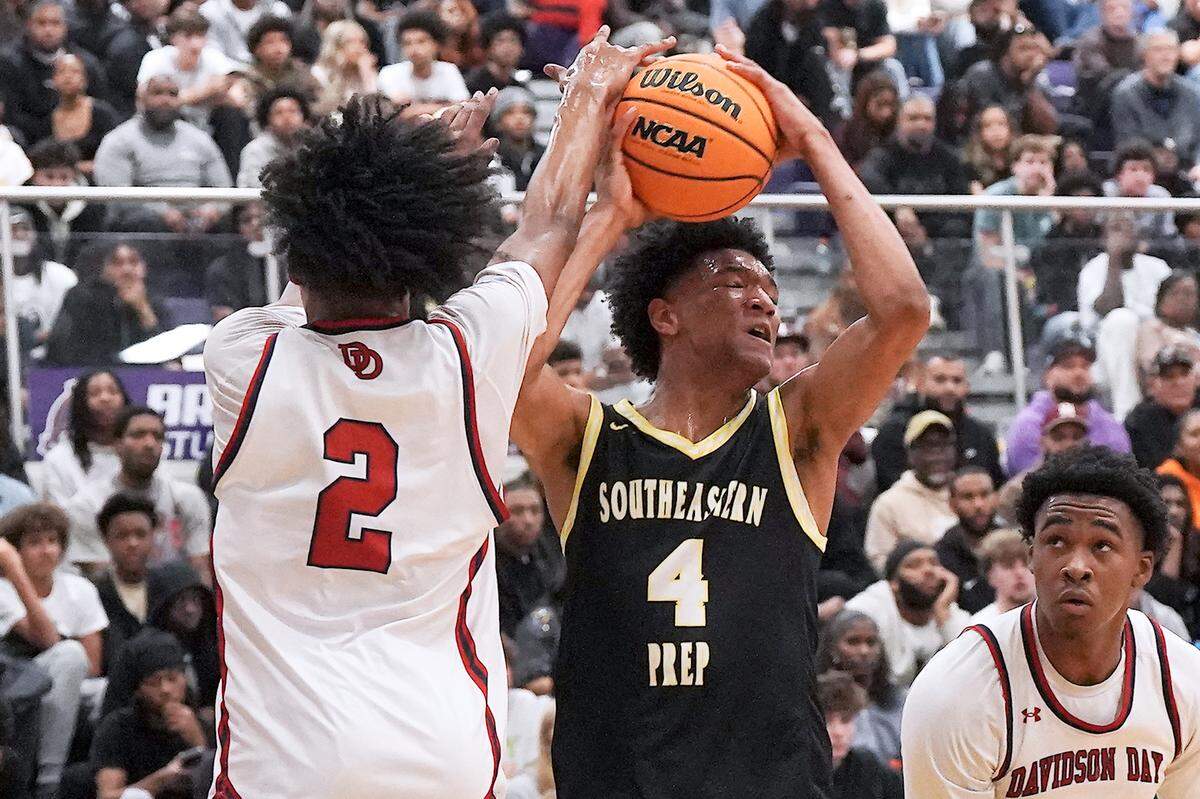 Davidson Day's Justyn Whitfield (2) gets a hand on the shot from Southeastern Prep's CJ Rosser, Jr. (4) during the first half. The Davidson Day Patriots and the Southeastern Prep Academy National Falcons met in the John Wall Holiday Tournament in Raleigh, N.C. on December 27, 2025.