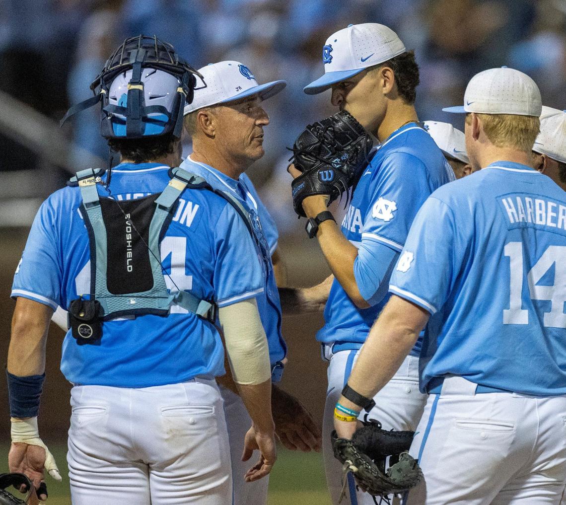 North Carolina coach Scott Forbes has a word with starting pitcher Jason Decaro (29) before removing him from the mound in the seventh inning against West Virginia during the NCAA Super Regional on Saturday, June 8, 2024 at Boshamer Stadium in Chapel Hill, N.C.