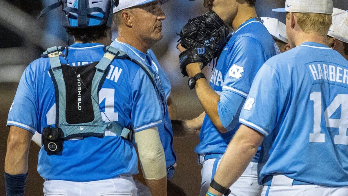 North Carolina coach Scott Forbes has a word with starting pitcher Jason Decaro (29) before removing him from the mound in the seventh inning against West Virginia during the NCAA Super Regional on Saturday, June 8, 2024 at Boshamer Stadium in Chapel Hill, N.C.
