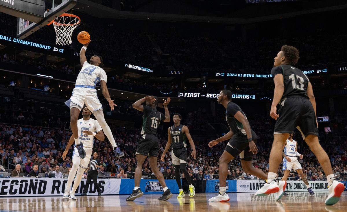 North Carolina’s Jae’Lyn Withers (24) breaks to the basket for a dunk in the first half against Wagner on Thursday, March 21, 2024 during the NCAA Tournament at Spectrum Center in Charlotte, N.C.