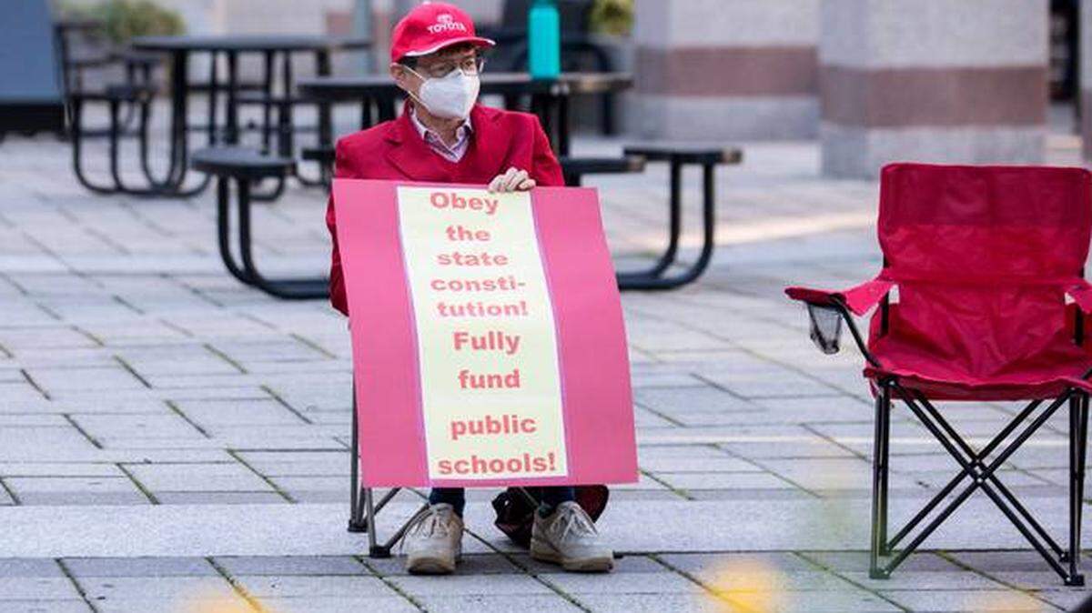 Patricia Long awaits the start of a prayer vigil urging the N.C. General Assembly to fund the Leandro Plan, in Raleigh, N.C. on Monday, Oct. 18, 2021.