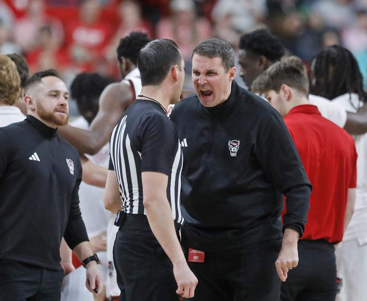 N.C. State head coach Will Wade speaks with an official during a timeout in the first half of the Wolfpack’s game against Miami on Saturday, Feb. 14, 2026, at Lenovo Center in Raleigh, N.C. 