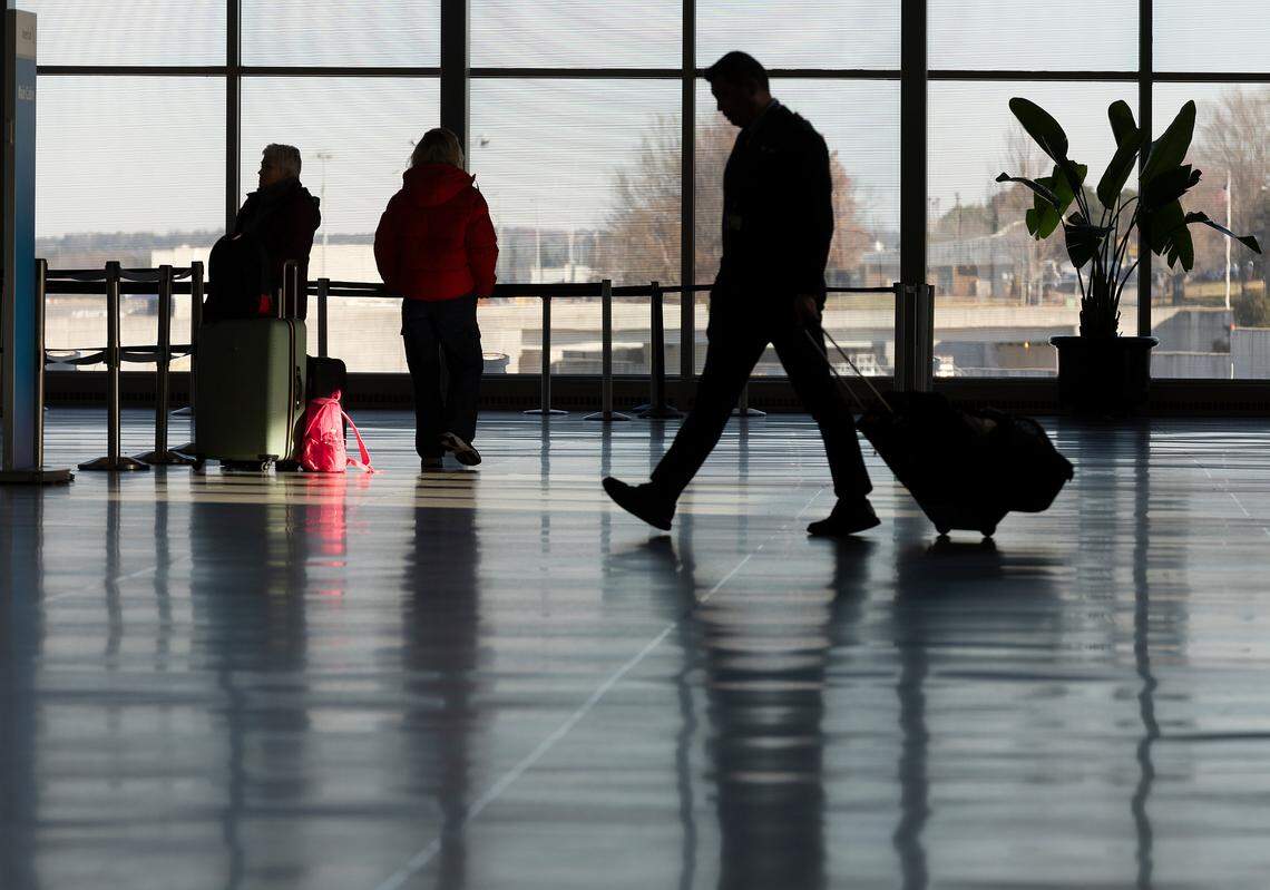 People walk through Raleigh-Durham International Airport on Tuesday, Dec. 24, 2024.