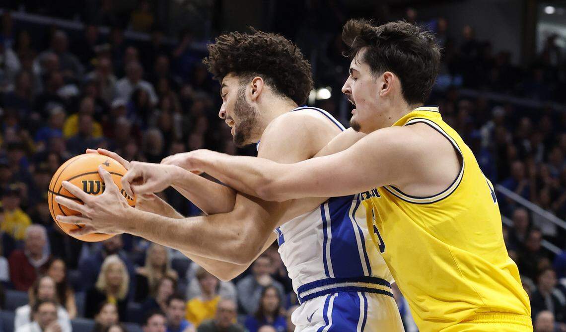 Duke’s Cameron Boozer (12) is fouled by Michigan's Aday Mara (15) during the first half of Duke’s game against Michigan in the Capital Showcase at Capital One Arena in Washington, D.C., Saturday, Feb. 21, 2026.