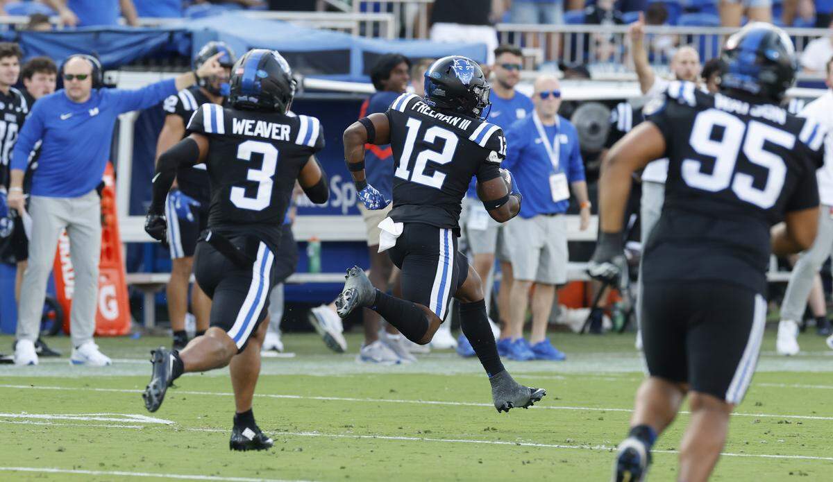 Duke linebacker Tre Freeman (12) returns an interception 67-yards late in the first half of N.C. State’s game against Duke at Wallace Wade Stadium in Durham, N.C., Sat. Sept. 20, 2025