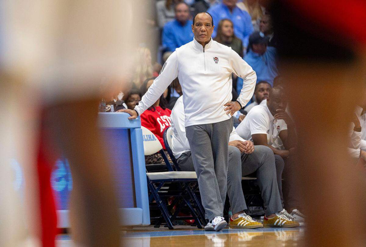 Down by 25 points in the first half against North Carolina, N.C. State coach Kevin Keatts leans against the scores table on Wednesday, February 19, 2025 in Chapel Hill, N.C.
