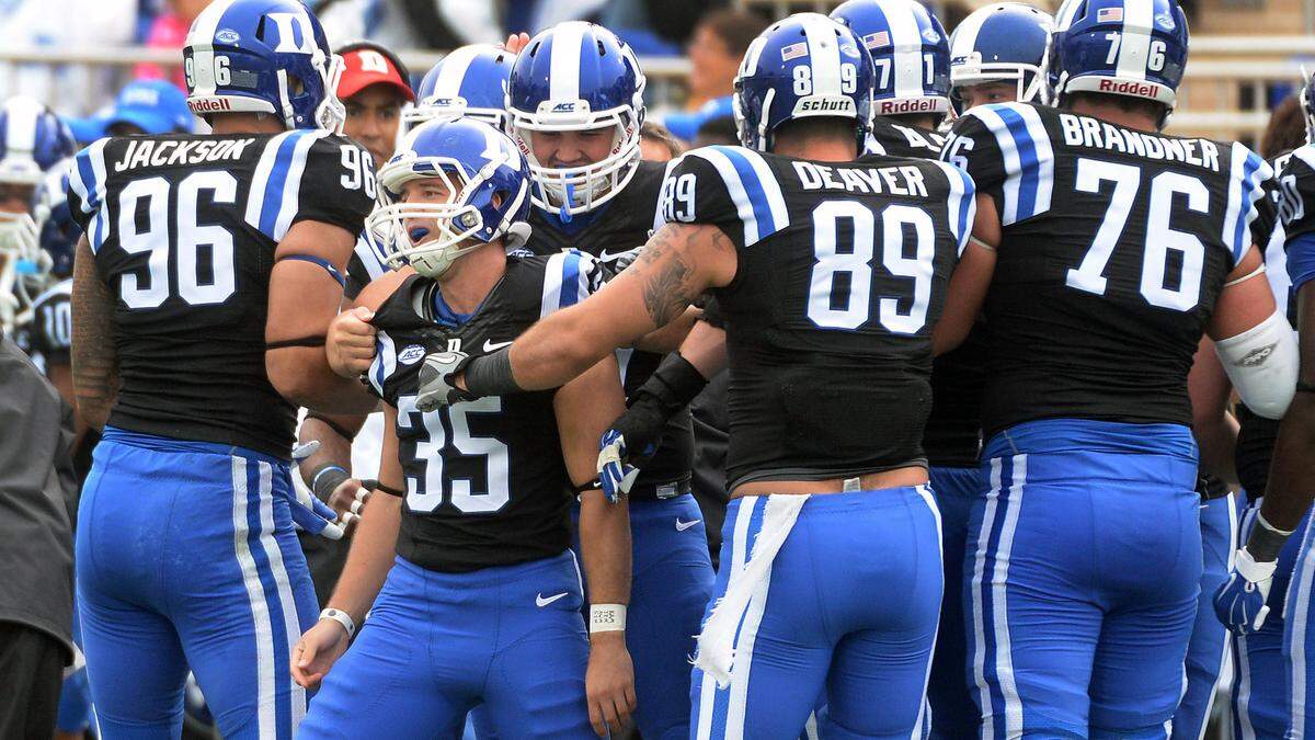 Duke place kicker Ross Martin (35) is congratulated by teammates after kicking, what would end up being, the game-winning field goal against the Eagles. Duke pulled out a narrow victory over Boston College 9-7 at Wallace Wade Stadium in Durham, N.C. Saturday, October 3, 2015.