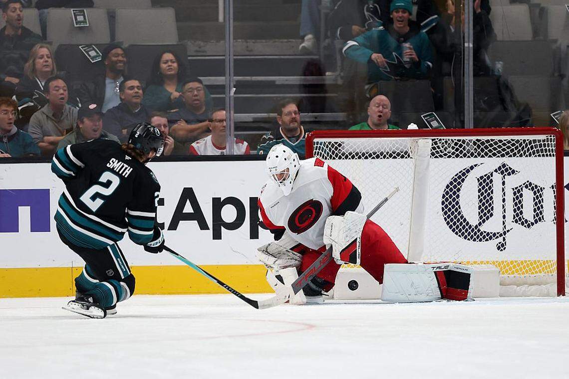 Brandon Bussi (32) of the Carolina Hurricanes makes a save on a shot taken by Will Smith of the San Jose Sharks during the first period at SAP Center on October 14, 2025 in San Jose, California.
