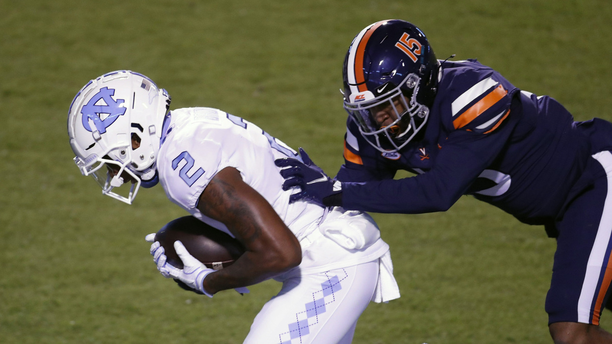 UNC’s Dyami Brown (2) scores in first half action as Virginia’s De’Vante Cross defends Saturday night, Oct. 31, 2020.