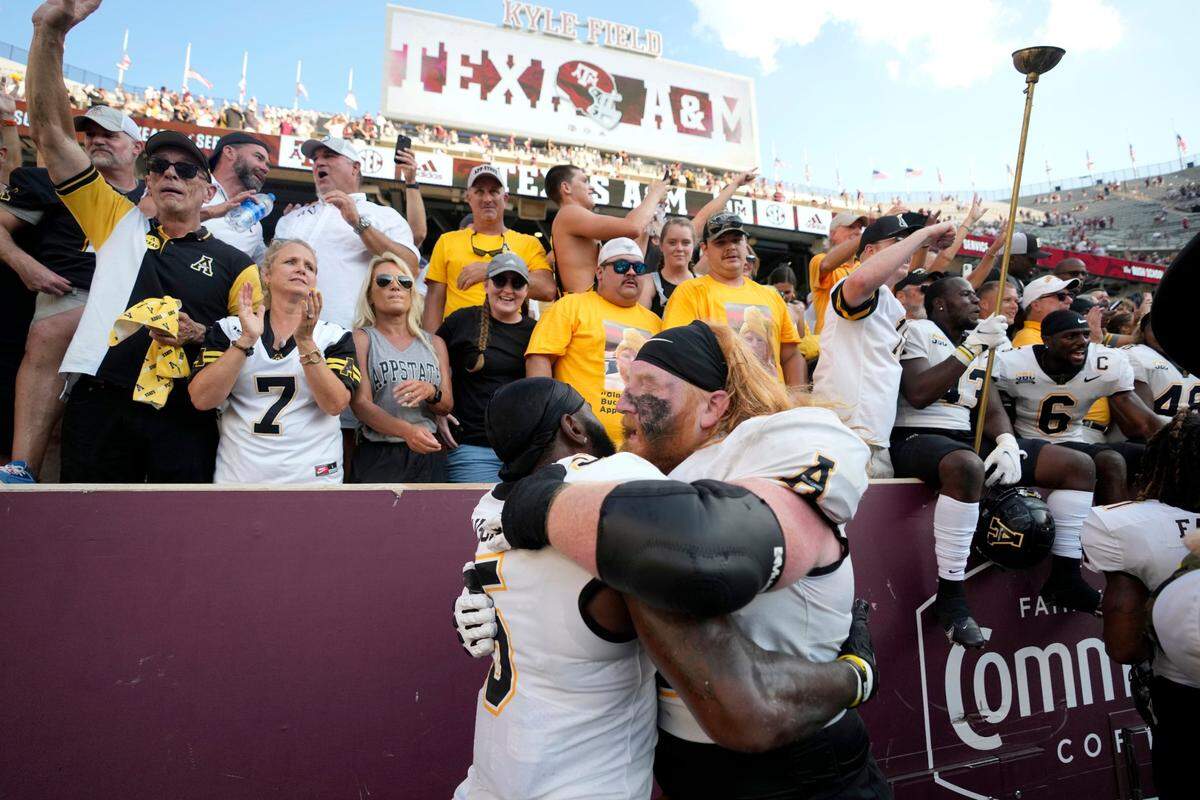 Appalachian State offensive lineman Bucky Williams, right, celebrates with Nate Noel, left, after the team’s 17-14 win over No. 6 Texas A&M in an NCAA college football game Saturday, Sept. 10, 2022, in College Station, Texas.