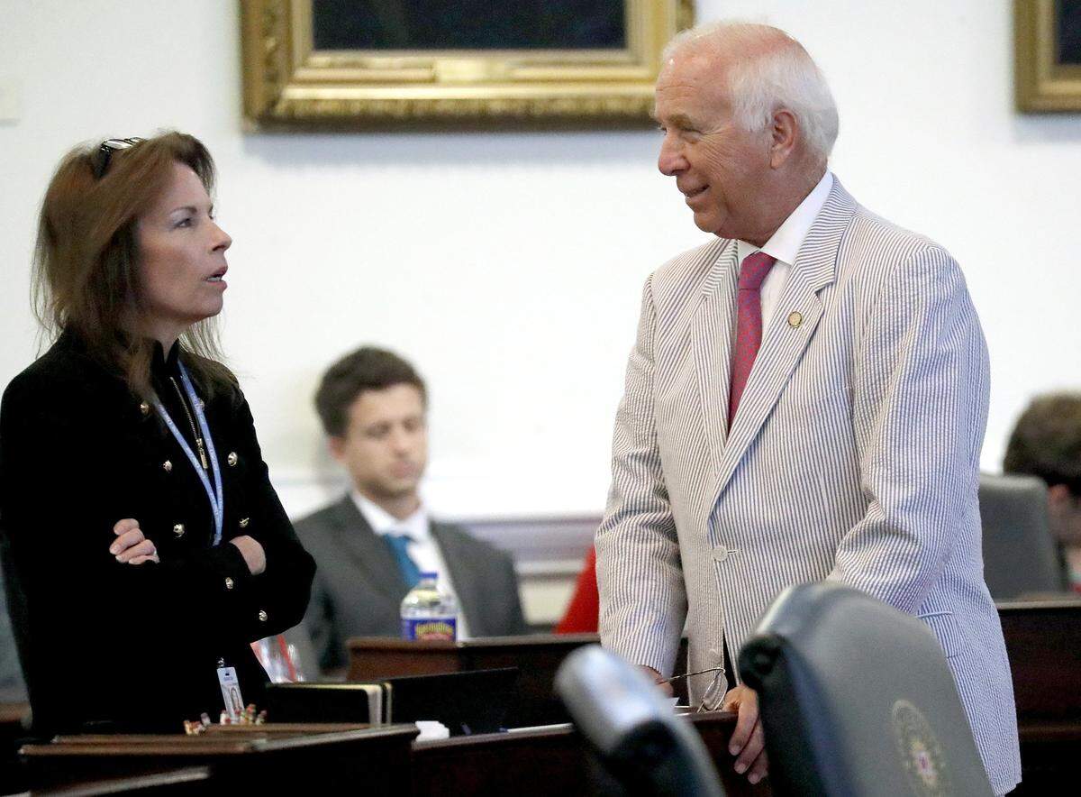 N.C. Sen. Tamara Barringer, R-Wake, left, and Sen. John Alexander, R-Wake, confer on the floor of the Senate at the Legislative Building in Raleigh on June 14, 2018.