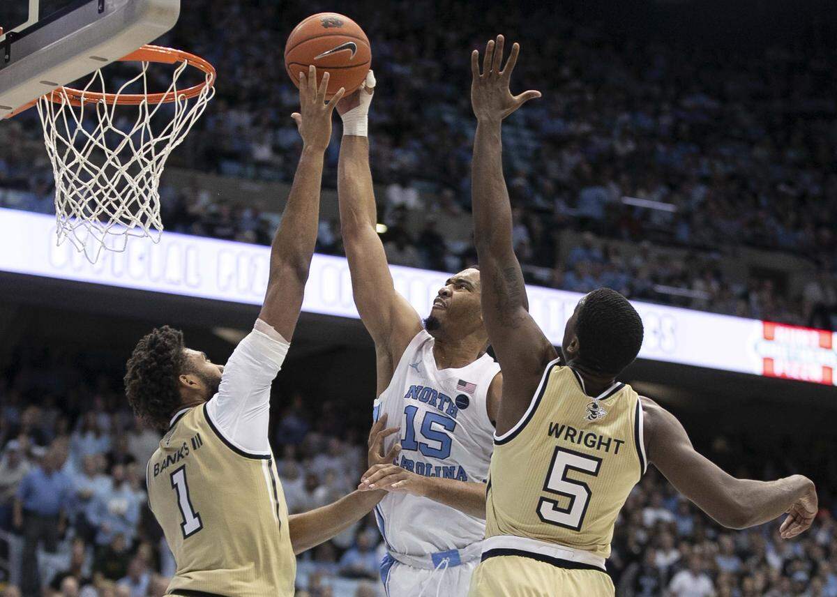 Georgia Tech’s James Banks III (1) and Moses Wright (5) defend North Carolina’s Garrison Brooks (15) in the first half on Saturday, January 4, 2020 at the Smith Center in Chapel Hill, N.C.