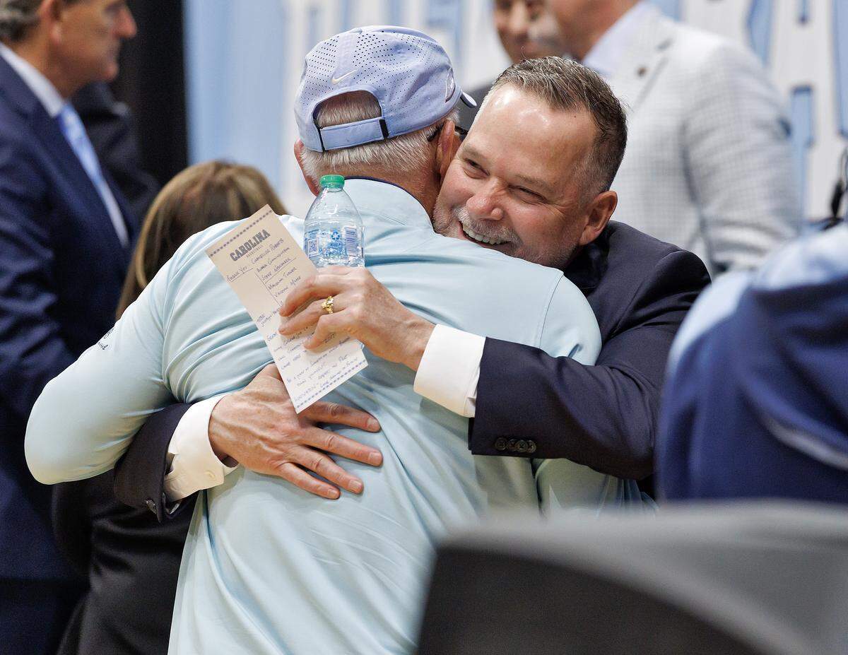 New North Carolina men’s basketball head coach Michael Malone receives a hug following an introductory press conference at the Smith Center on Tuesday, April 7, 2026, in Chapel Hill, N.C. 
