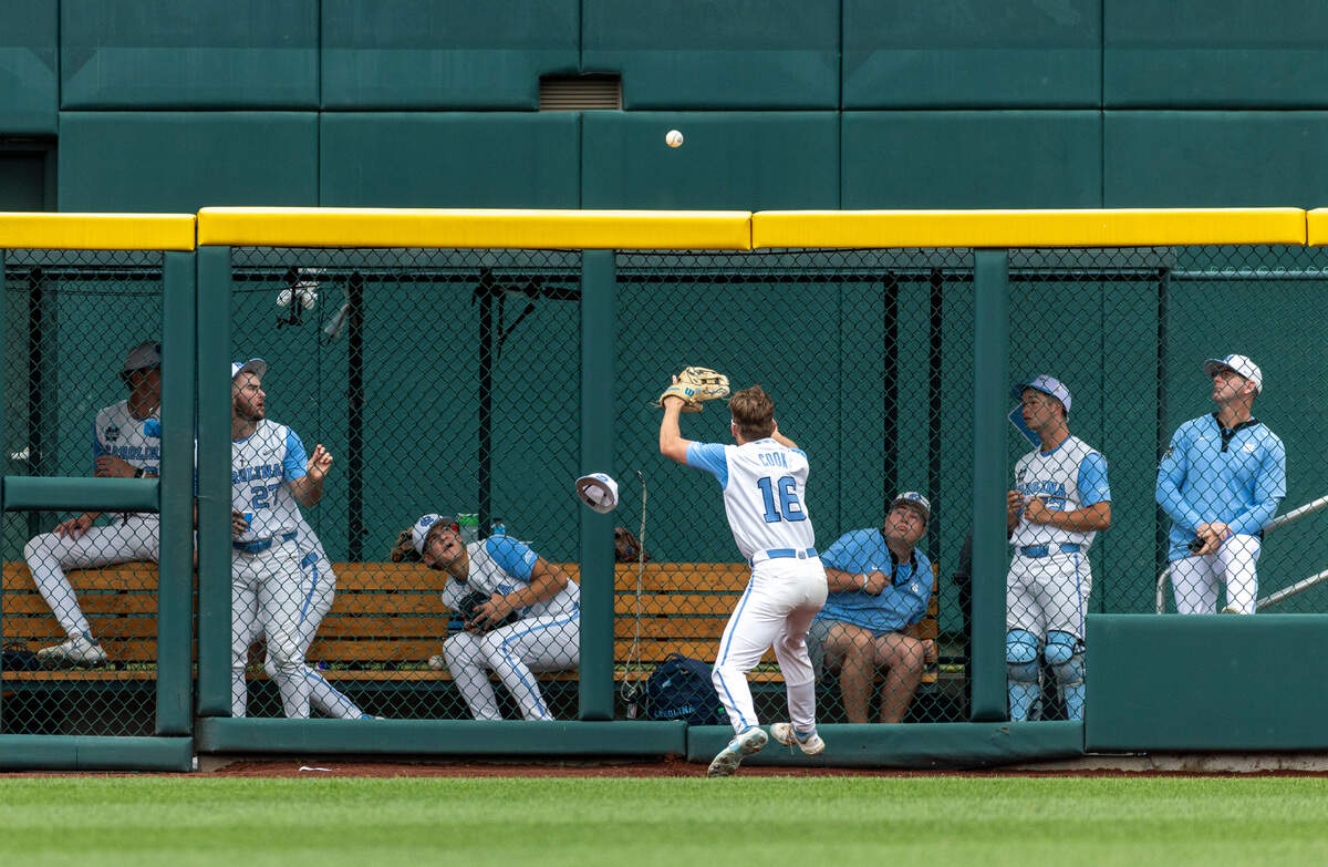 North Carolina left fielder Casey Cook (16) chases a home run ball by Florida State catcher Jaxon West to the fence enclosing the Tar Heels’ bullpen in the ninth inning during game nine of the College World Series on Tuesday, June 18, 2024 at Charles Schwab Field in Omaha, Nebraska.
