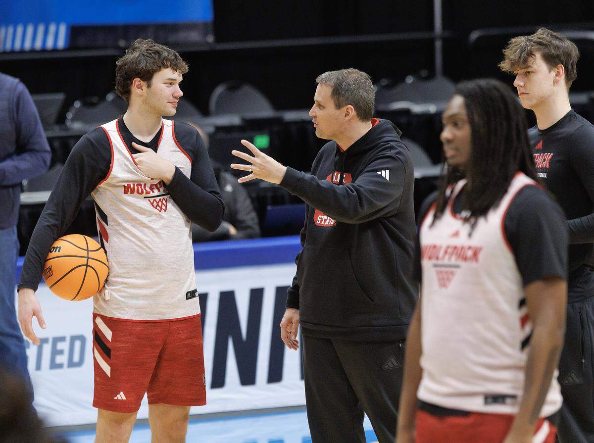 N.C. State head coach Will Wade speaks with Colt Langdon during practice at University of Dayton Arena in Dayton, Ohio on Monday, March 16, 2026. The Wolfpack will face Texas in the First Four on Tuesday.