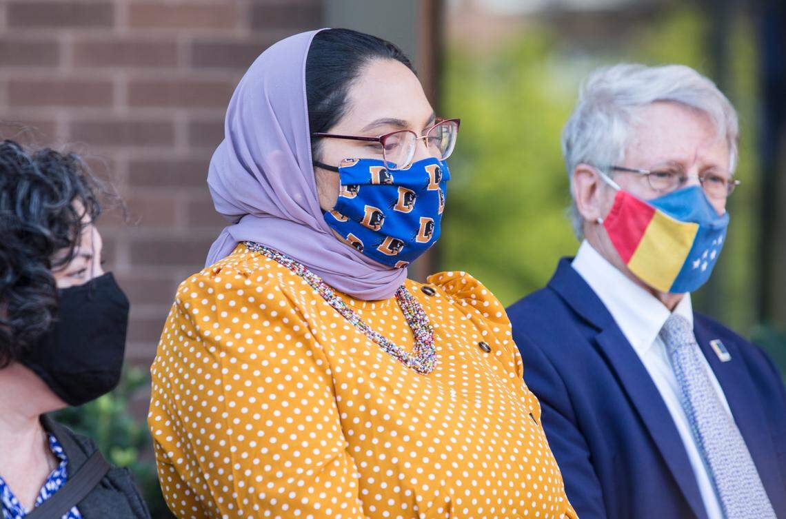 Durham County Commissioner Nida Allam, middle, Mayor Steve Schewel, right, and City Council member Javiera Caballero, left, listen to speakers during a press conference about Afghan refugee resettlement outside City Hall in Durham, N.C. on Monday, Aug. 30, 2021.