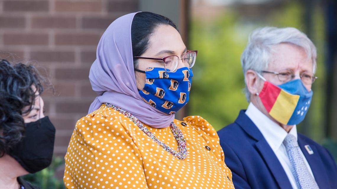 Durham County Commissioner Nida Allam, middle, Mayor Steve Schewel, right, and City Council member Javiera Caballero, left, listen to speakers during a press conference about Afghan refugee resettlement outside City Hall in Durham, N.C. on Monday, Aug. 30, 2021.