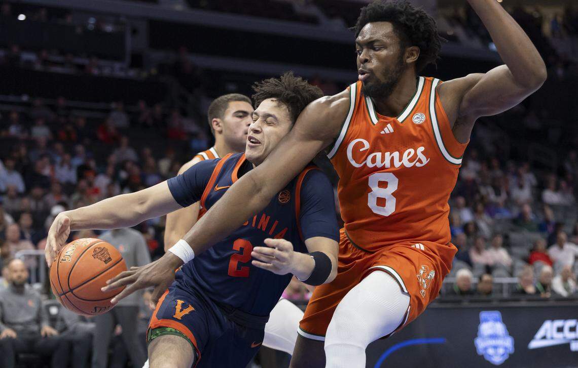 Miami center Ernest Udeh Jr. defends Virginia guard Chance Mallory in the first half on Friday, March 13, 2026, during the semifinals of the ACC Tournament at Spectrum Center in Charlotte, N.C.