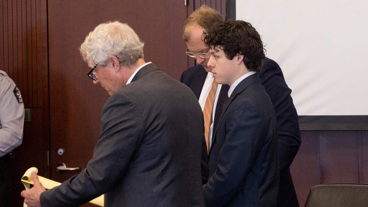 Landen Glass, right stands in court with his attorneys Robert Smith Jr., left, and Russell Babb during a bond hearing at the Wake County Justice Center in Raleigh. Glass is the driver who lost control of his truck and struck and killed an 11-year-old girl in the Raleigh Christmas parade. He faces felony involuntary manslaughter charge.