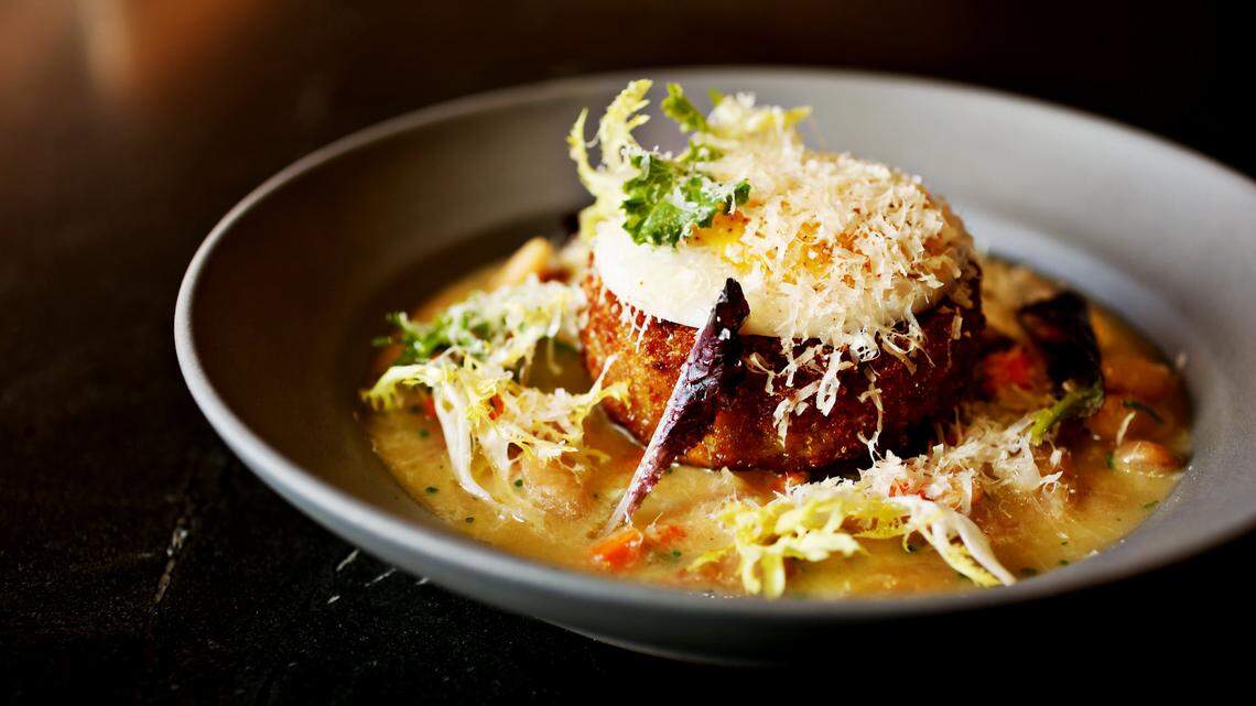From the winter 2020 menu, crispy duck croquette is served over cannellini beans in a garlicky broth that’s evocative of a cassoulet, and topped with a poached duck egg at Crawford & Son in Raleigh.