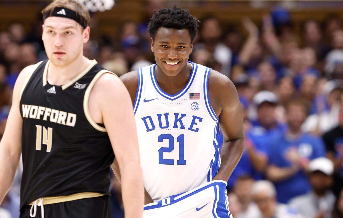 Duke’s Patrick Ngongba II (21) smiles as he comes off the court for the first time during the first half of Duke’s game against Wofford at Cameron Indoor Stadium in Durham, N.C., Saturday, Nov. 16, 2024. Wofford’s Kyler Filewich (14) is to the left.