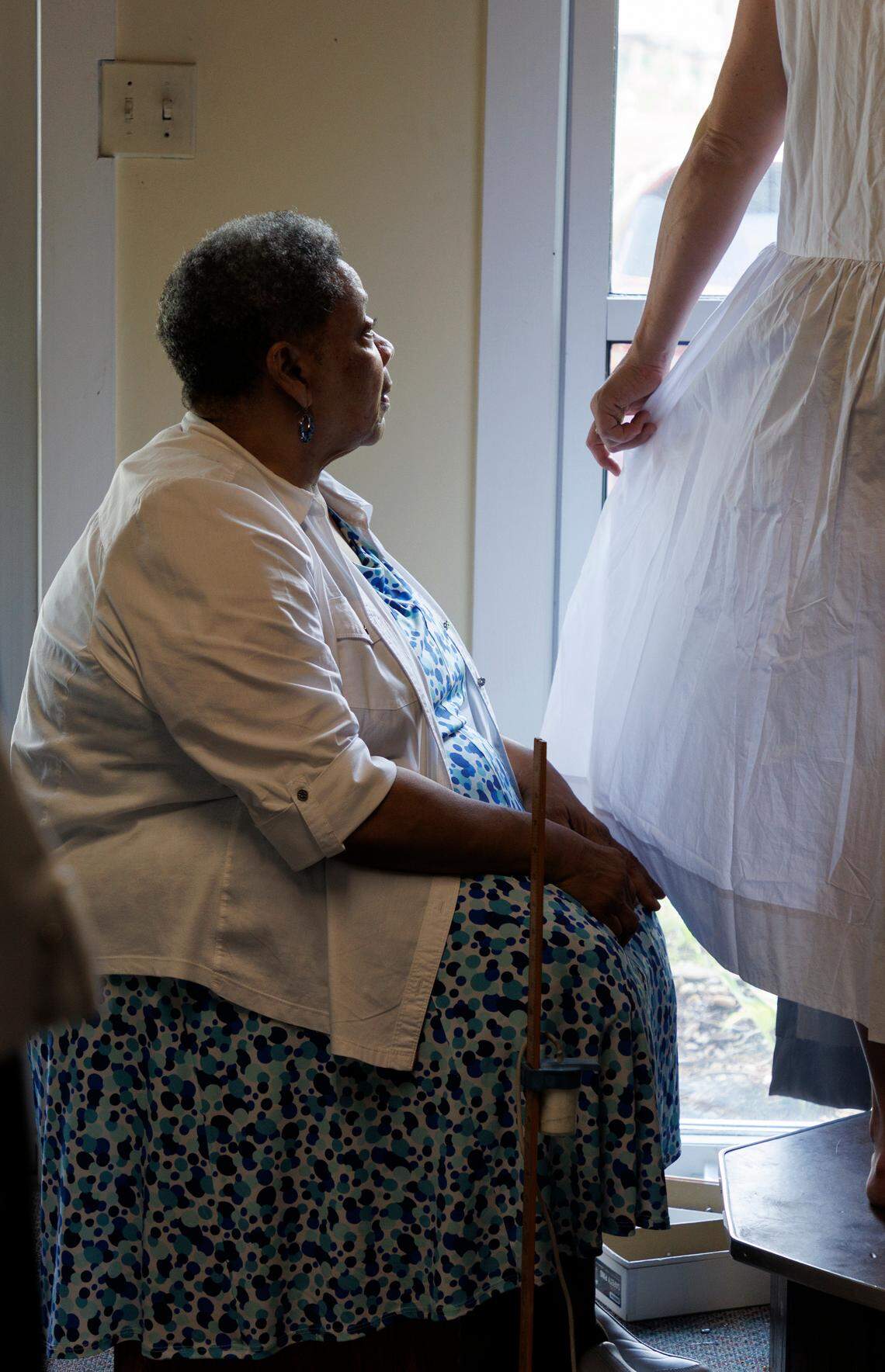 Linda Laws, owner of Stitches Tailor Shop, helps a customer at the shop on Monday, July 15, 2024, in Durham, N.C. After 28 years at its current location on Hillsborough Road, Laws is preparing to relocate the business.