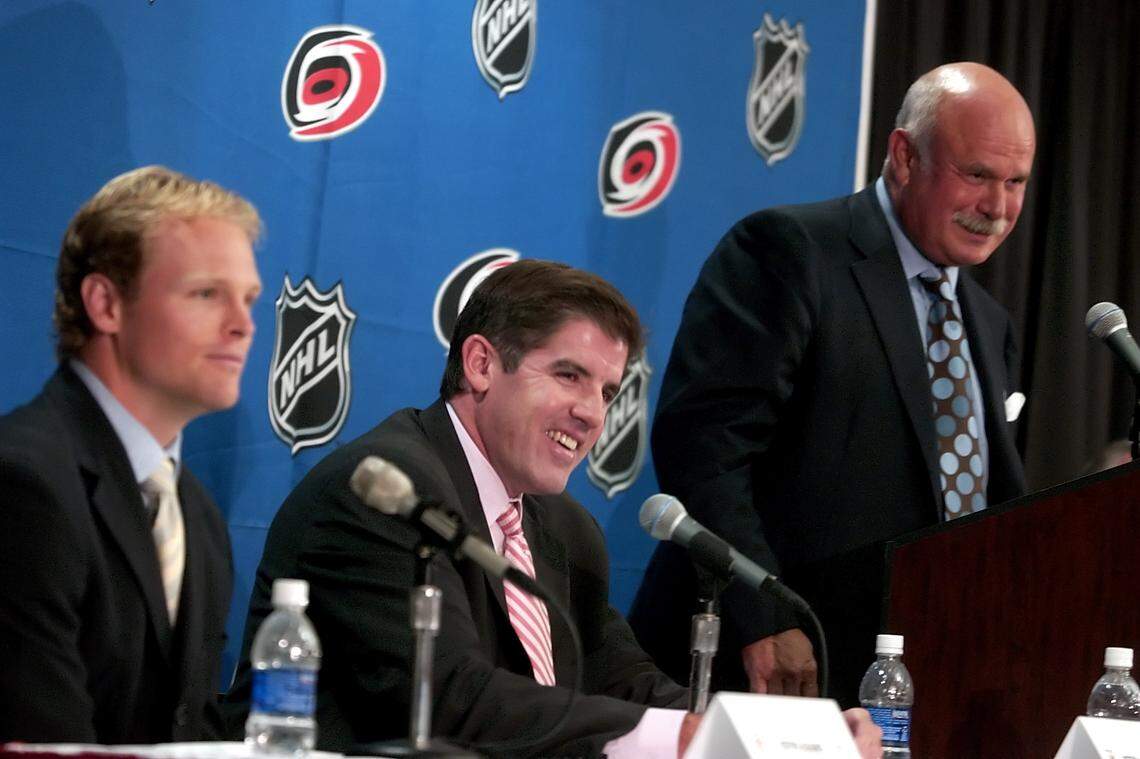 Carolina Hurricanes player Kevyn Adams, left, coach Peter Laviolette and owner Peter Karmanos speak at a press conference at the RBC Center July 22, 2005, about the new NHL collective bargaining agreement.