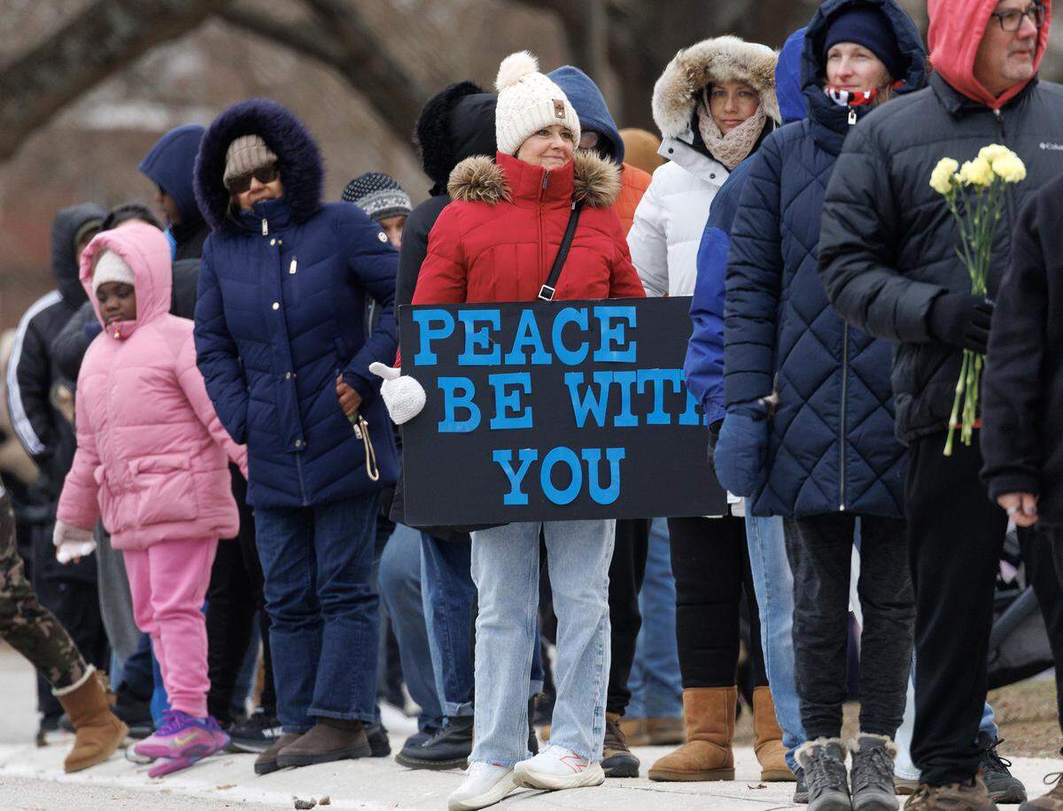 Crowds line Umstead Drive while awaiting a procession of Buddhist monks at Dorothea Dix Park as a part of the Walk for Peace on Saturday, Jan. 24, 2026, in Raleigh, N.C.