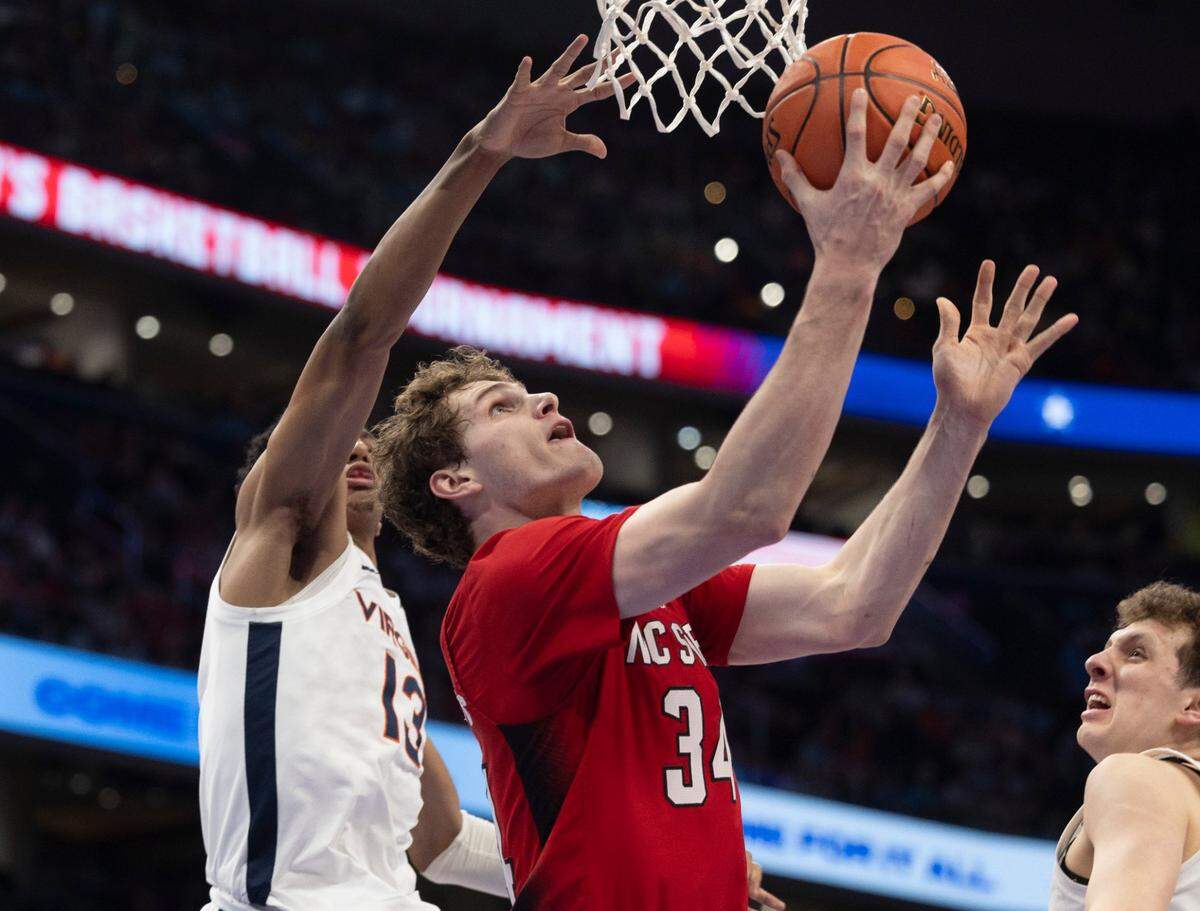 N.C. State’s Ben Middlebrooks (34) drives to the basket against Virginia’s Ryan Dunn (13) in the first half during the semi-finals of the ACC Men’s Basketball Tournament at Capitol One Arena on Friday, March 15, 2024 in Washington, D.C.