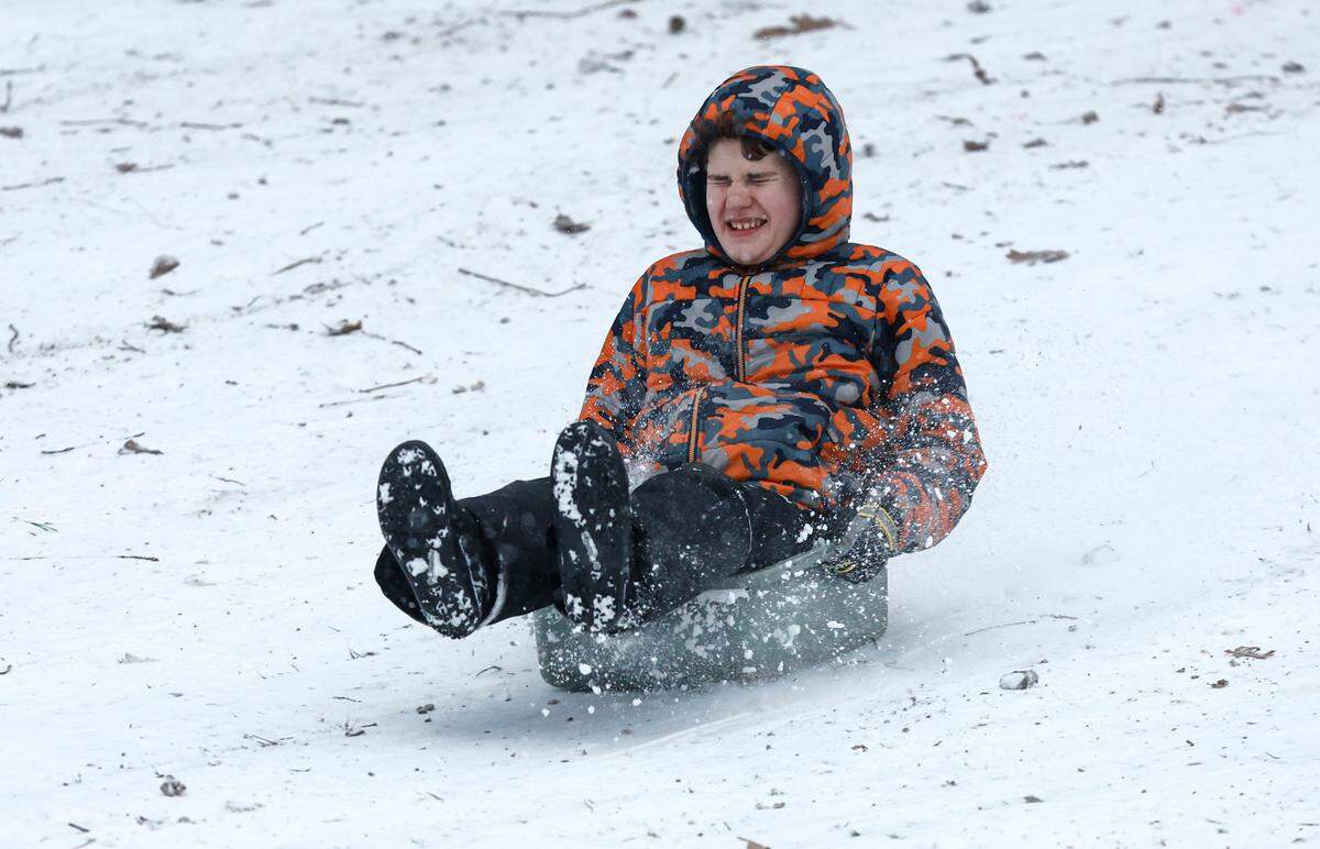 Harrison Viren, 13, of Apex uses a bus tub as his sled while sledding in Dix Park in Raleigh Wednesday afternoon, Feb. 19, 2025.