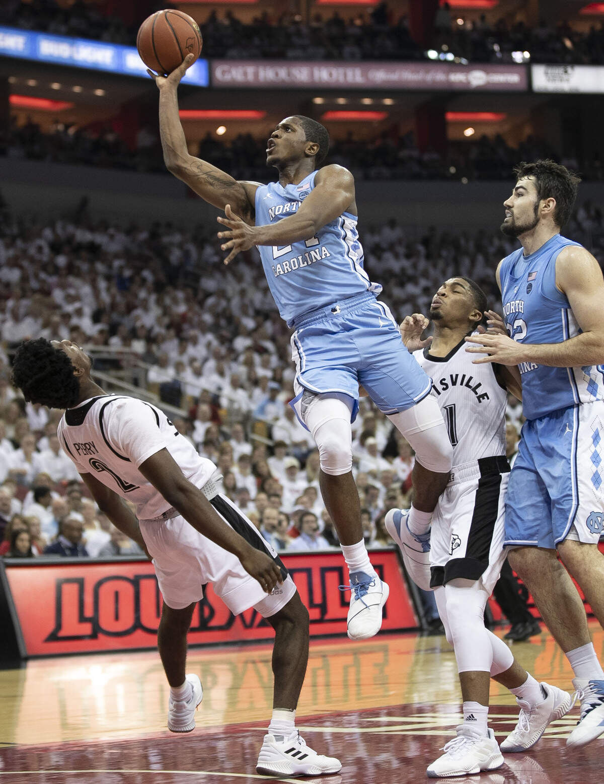 North Carolina’s Kenny Williams (24) drives to the basket against Louisville’s Darius Perry (2) during the first half on Saturday, February 2, 2019 at the KFC Yum! Center in Louisville, Ky. Williams had 10 points and in the Tar Heels’ victory over Louisville.