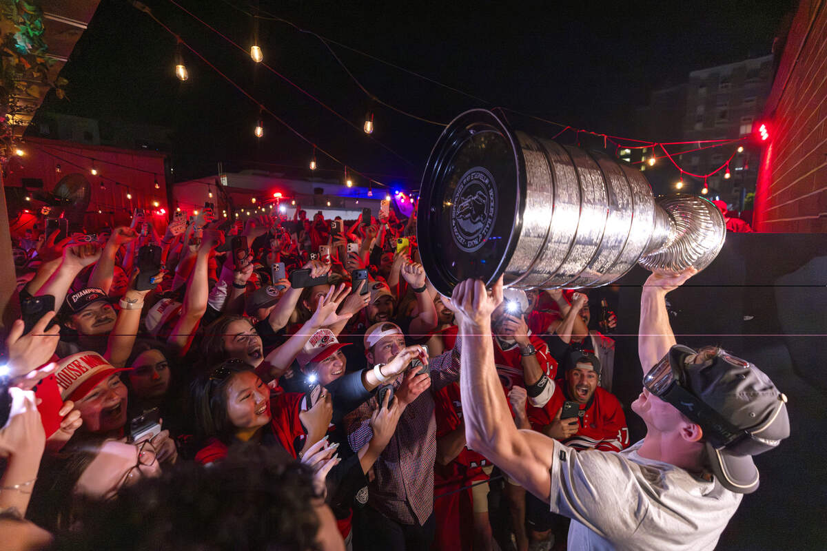 Carolina Hurricanes fans celebrate the team's Stanley Cup Final victory at Teets in Raleigh's Glenwood South district as the Stanley Cup, accompanied by Hurricanes players and staff, makes an appearance during a victory celebration Monday, June 15, 2026. The Hurricanes defeated the Vegas Golden Knights 4-2 in the Stanley Cup Final to win the franchise's second championship since 2006.