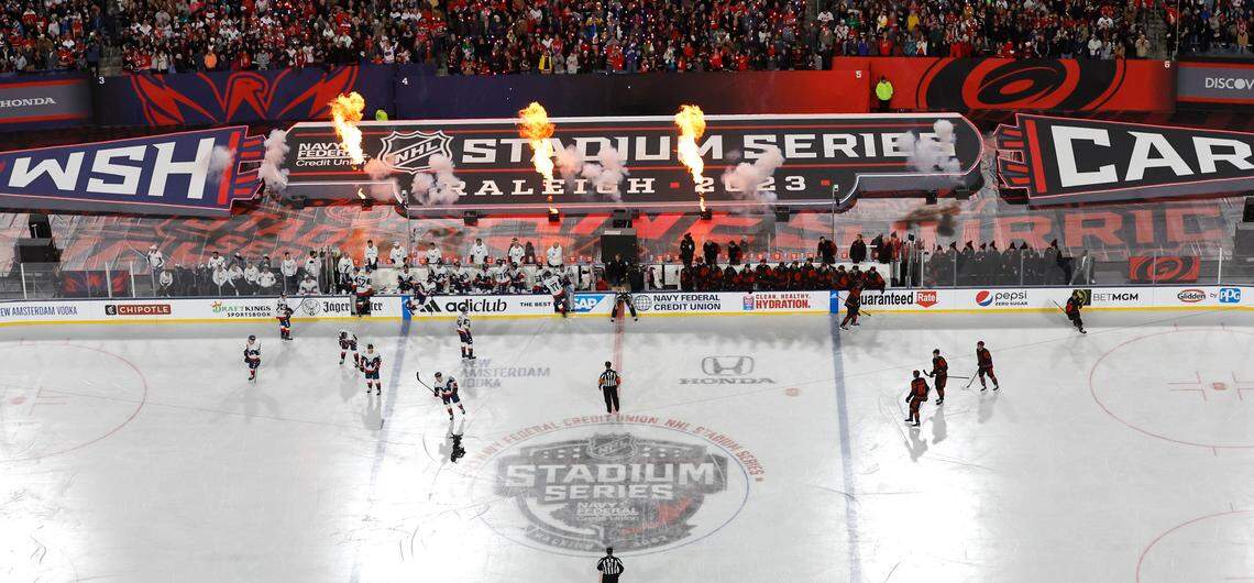 Pyrotechnics go off to celebrate after Carolina’s Jesperi Kotkaniemi (82) scored during the first period of the NHL Stadium Series game between the Carolina Hurricanes and the Washington Capitals at Carter-Finley Stadium in Raleigh, N.C., Saturday, Feb. 18, 2023.