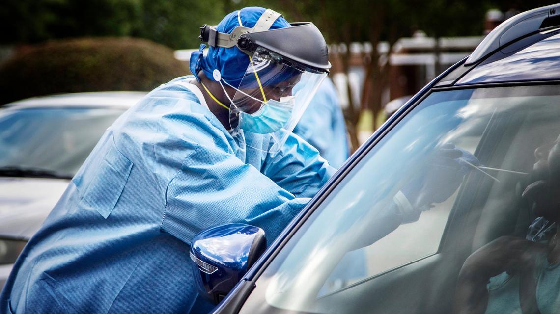 Gandhi Elamin conducts a coronavirus test at the Avery Street Recreation Center in Garner Friday, July 10, 2020. About 400 people received tests at the pop up testing site.