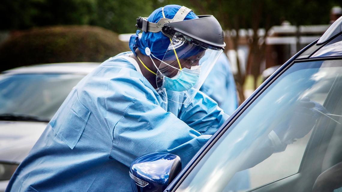 Gandhi Elamin conducts a coronavirus test at the Avery Street Recreation Center in Garner Friday, July 10, 2020. About 400 people received tests at the pop up testing site.