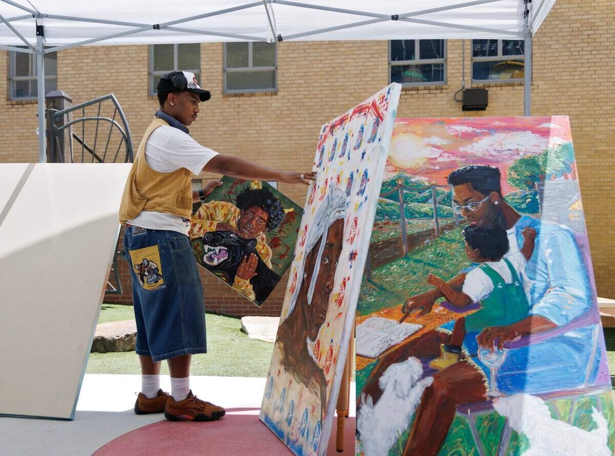 Tyler Jones displays artwork prior to painting a mural outside Marbles Kids Museum during a Juneteenth celebration on Thursday, June 19, 2025, in Raleigh, N.C.